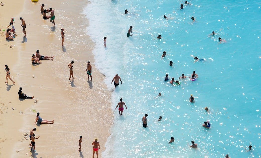 people swimming on the beach